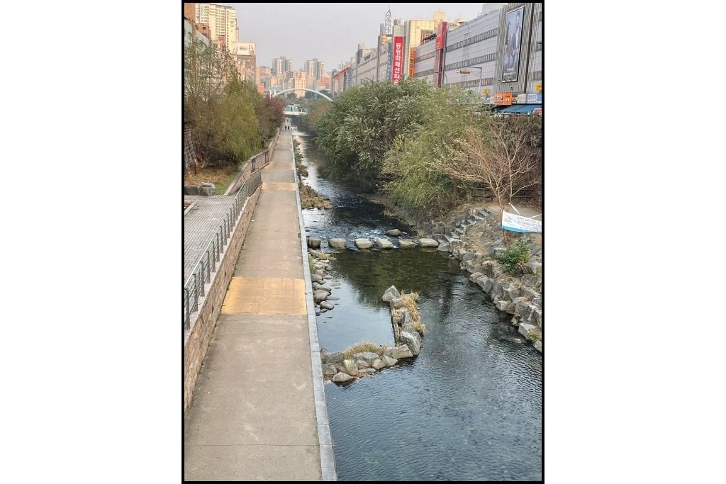 Cheonggyechon stream in Seoul, stone walls , trees and water.