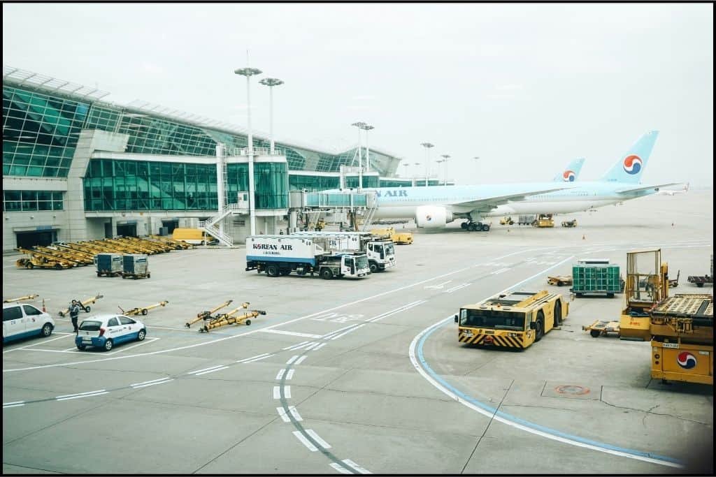 Incheon airport view of a plane at the gate and some luggage trucks