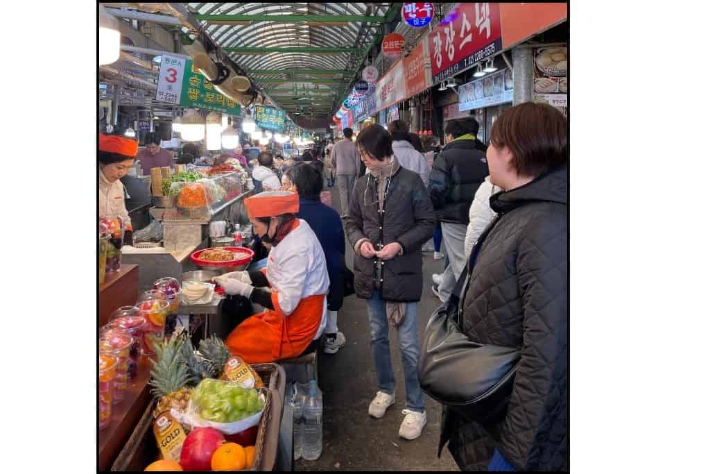 People shopping at a traditional market in Seoul