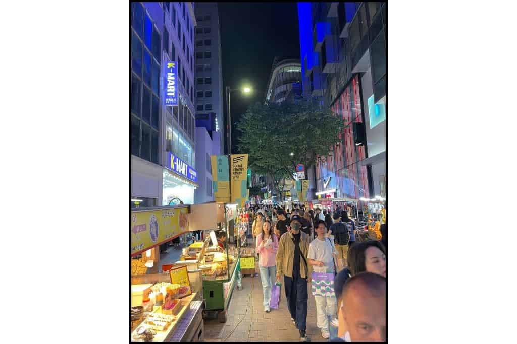 A view of tourists at night in Myeongdon
