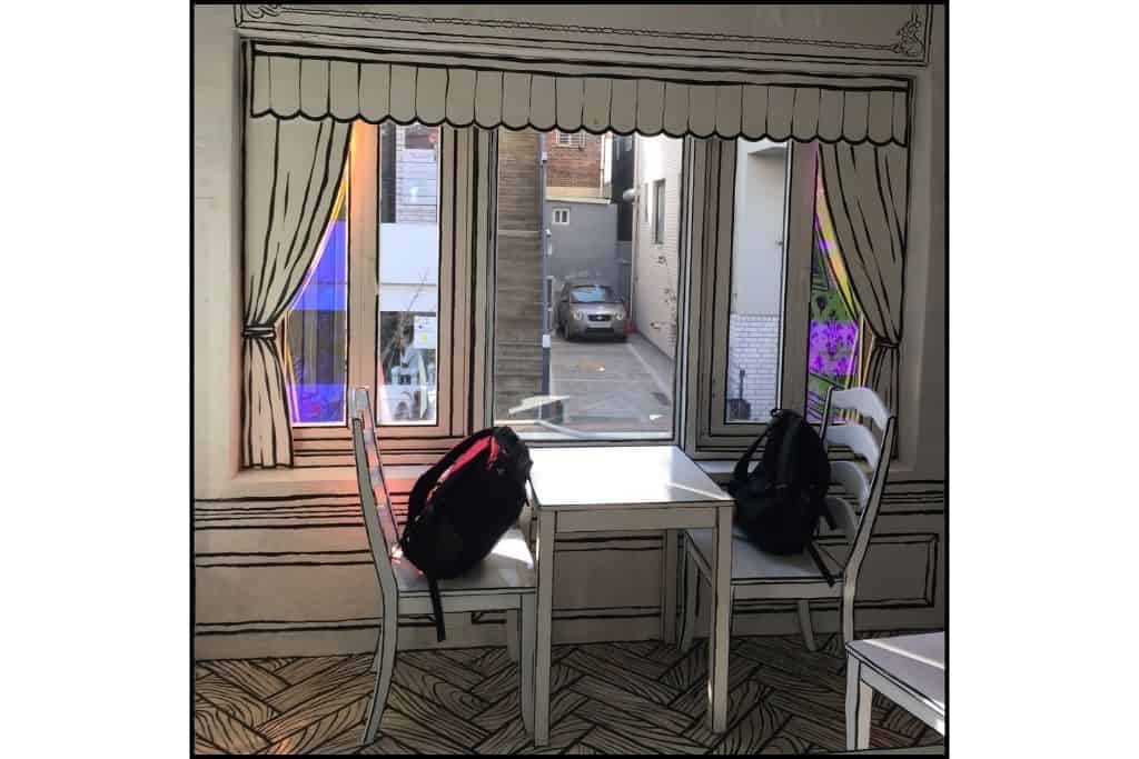Backpacks at a table in a cafe to hold the spot in South Korea
