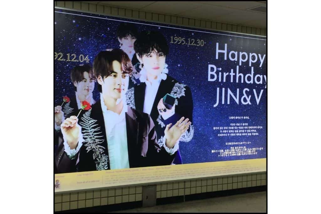Happy Birthday sign for Jin and V from BTS in the subway station.