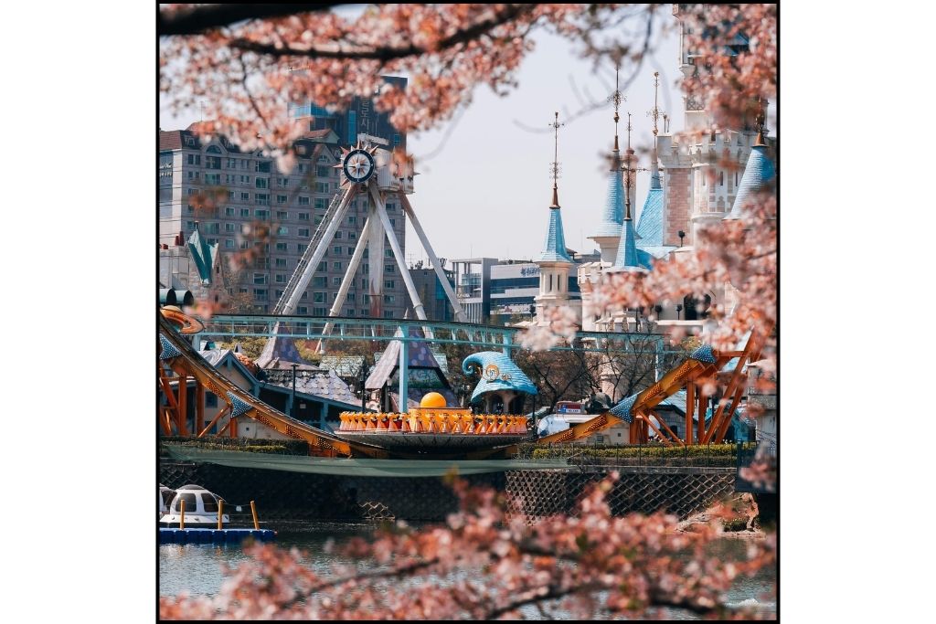 A Lotte World ride framed with cherry blossoms in Seoul