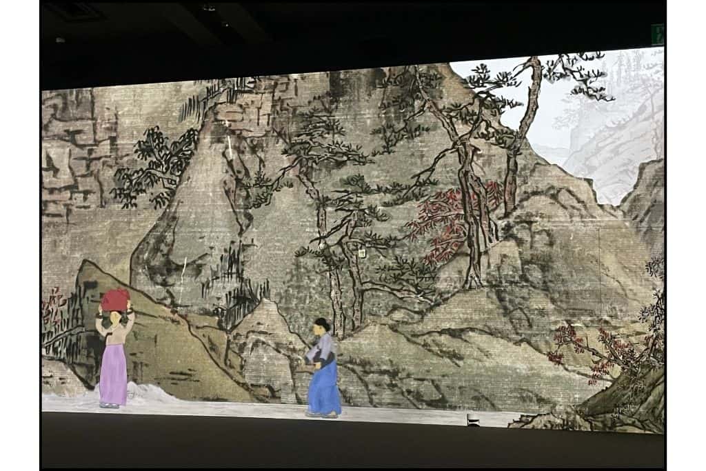 a traditional scene of Korean woman against the background of a mountain, part of the immersive digital display at the museum
