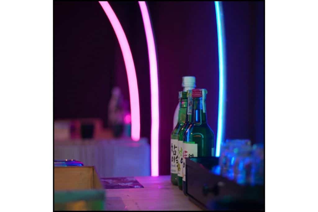 Neon lights and soju bottles at the bar in a club in South Korea
