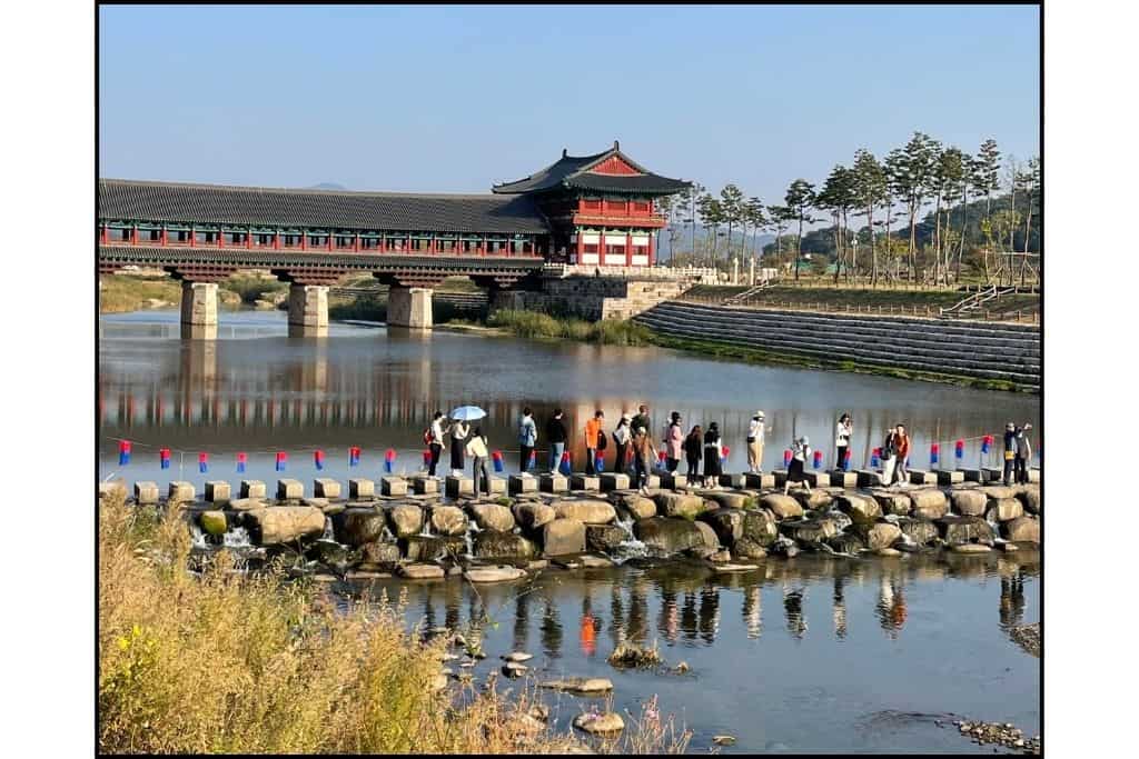 Woljeonggyo Bridge in Gyeongju, with people crossing the river, showcasing its traditional architecture and scenic beauty, making it a perfect stop for a day trip.