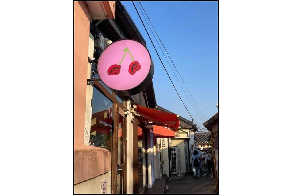 Gyeongju cherry wine shop on Hwanglidangil Street, perfect for a day trip, displaying bottles of locally made cherry wine in a cozy storefront, offering a taste of the region’s unique flavors.