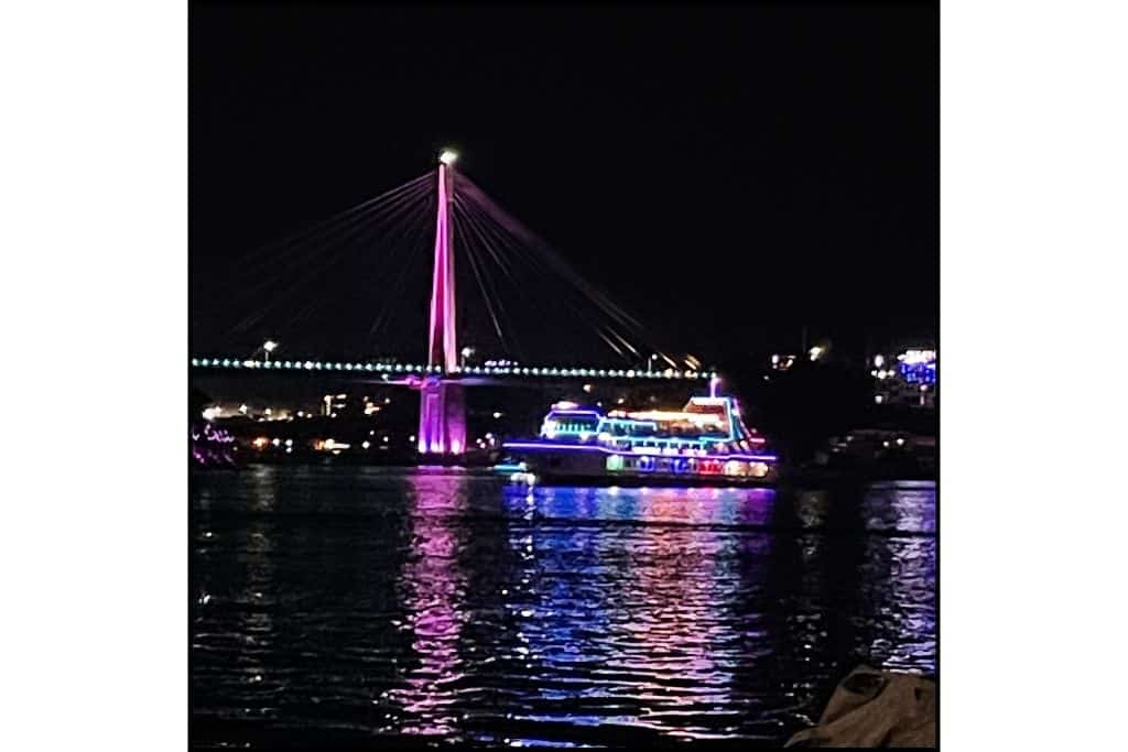 Nighttime view of the bridge and night cruise ship in Yeosu lit up