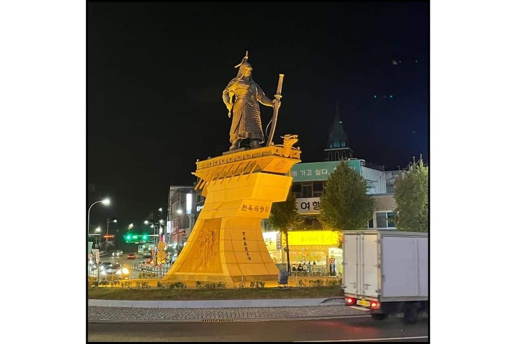 A nighttime view of the Yi Sun Sin statue at night in Yeosu