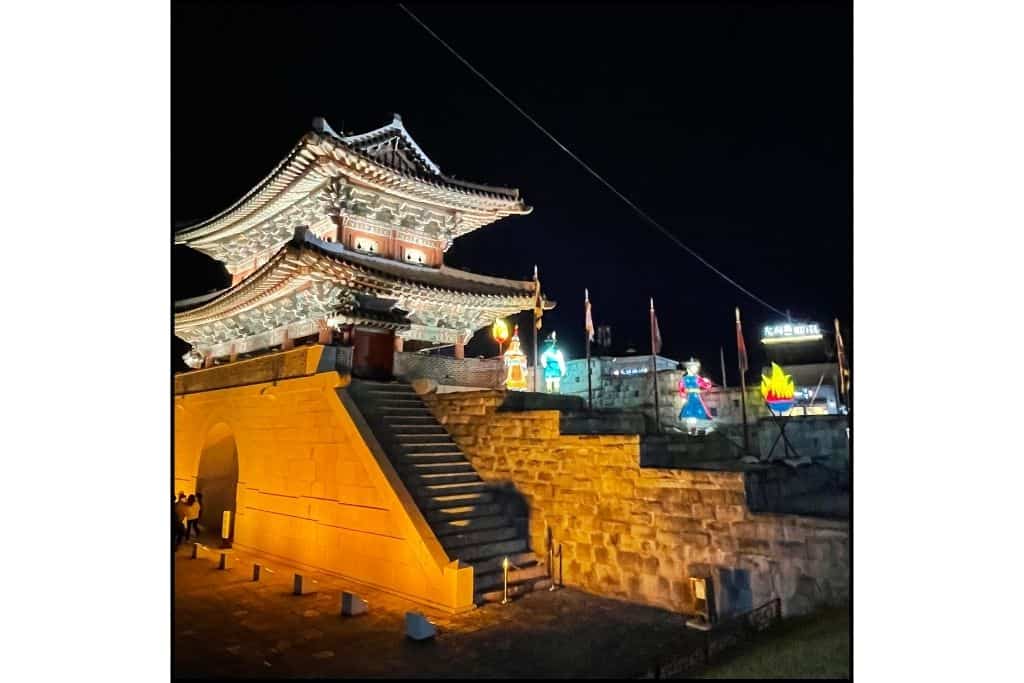 The Jinjuseong Fortress with lanterns in the background lit up at night