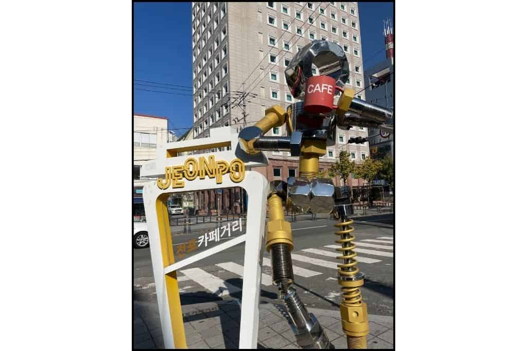 An art installation of a metal man indicating Jeonpo Cafe Street