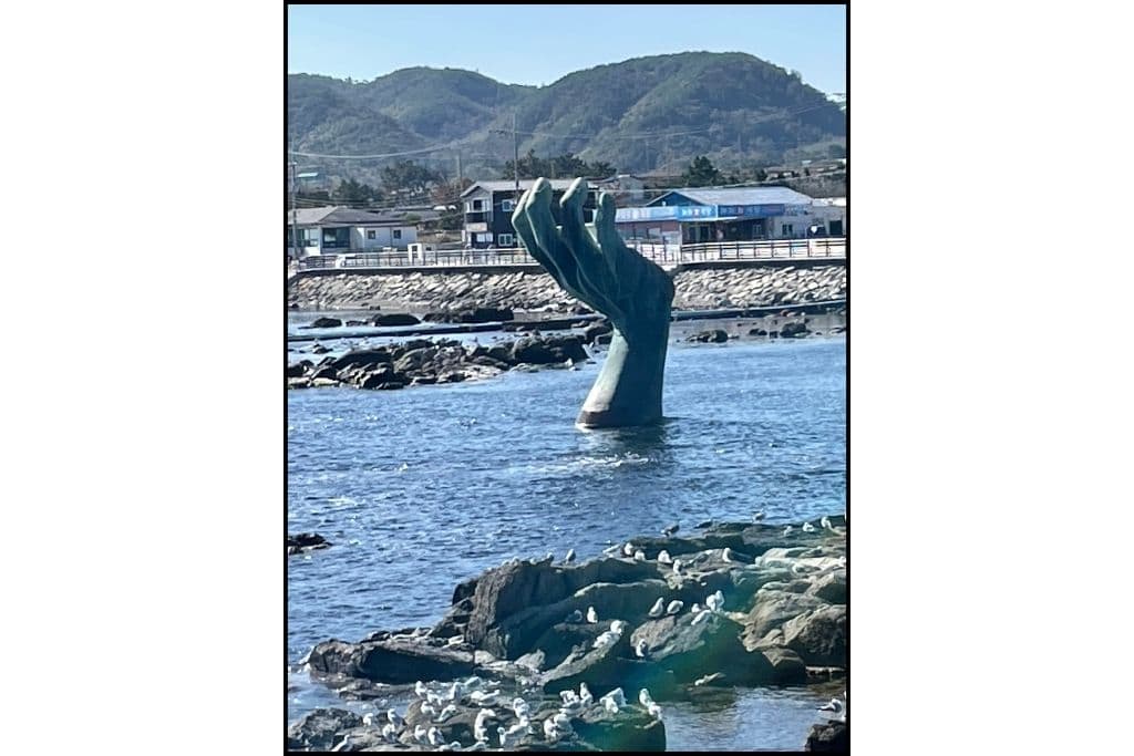 A different view of the Homigot Hand in the water, looking back at the shoreline , in Pohang
