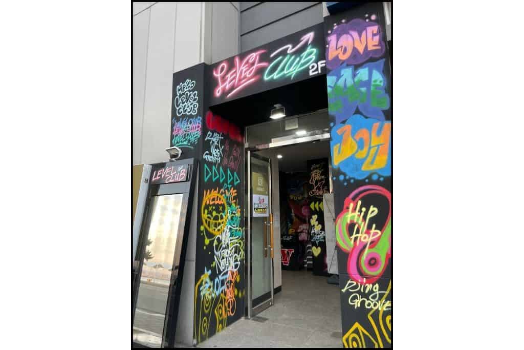 The door to a hip hop club, decorated with colorful graffiti, in South Korea