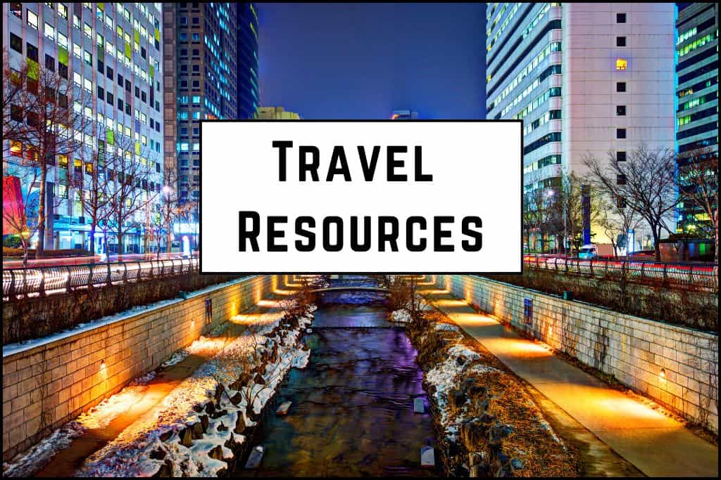 Nighttime view of Cheonggyecheon Stream illuminated by glowing lights, reflecting on the water in Seoul