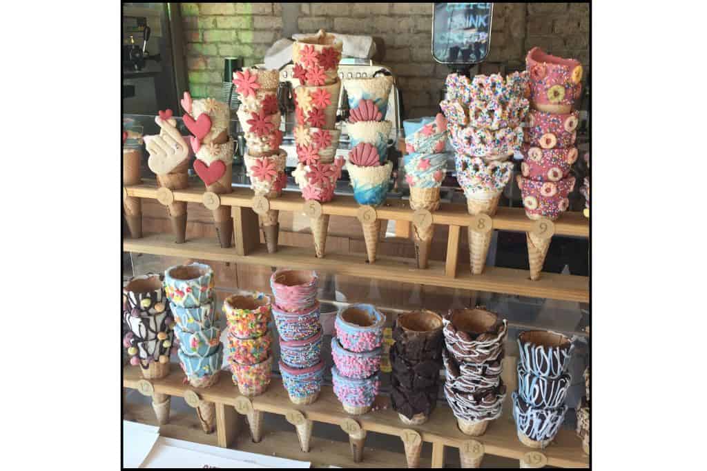 A display of colorful ice cream cones choices at Biseu Topping, featuring various cone options on Hapjeong Cherry Blossom st