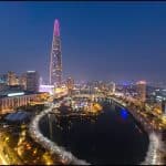 Night view of Seokchon Lake with the reflection of Lotte World Tower lit up in the background—one of the best things to do at night in Seoul.