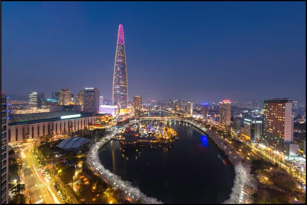 Night view of Seokchon Lake with the reflection of Lotte World Tower lit up in the background—one of the best things to do at night in Seoul.