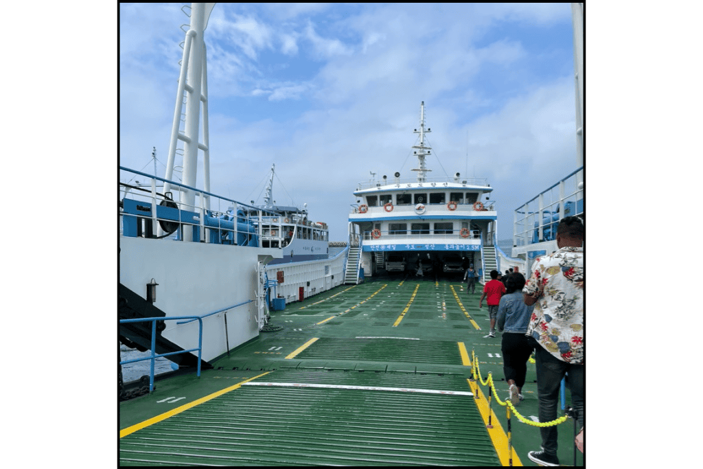 Passengers boarding a ferry bound for Udo Island from Jeju, South Korea, under a bright blue sky — a popular way to reach this scenic offshore destination.
