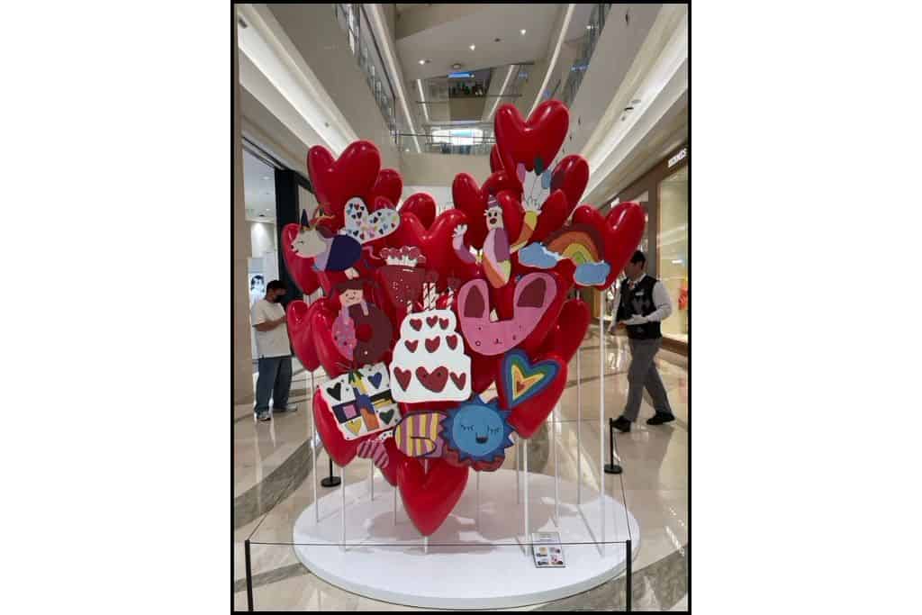 Art installation made of many small red hearts forming one large heart, displayed at a mall in South Korea.