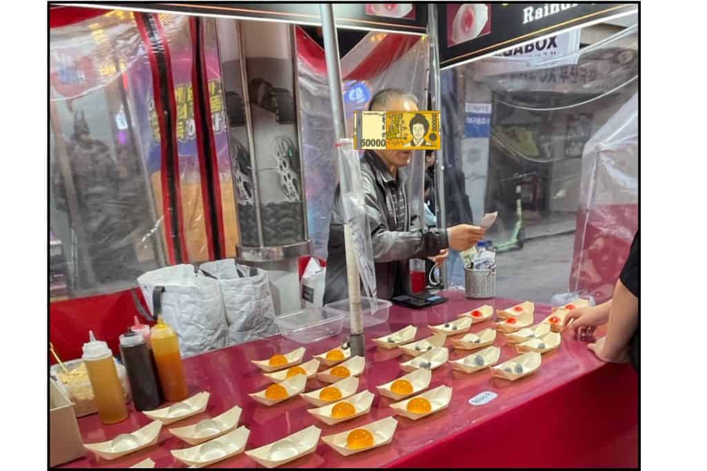 A food vendor accepting cash in South Korea