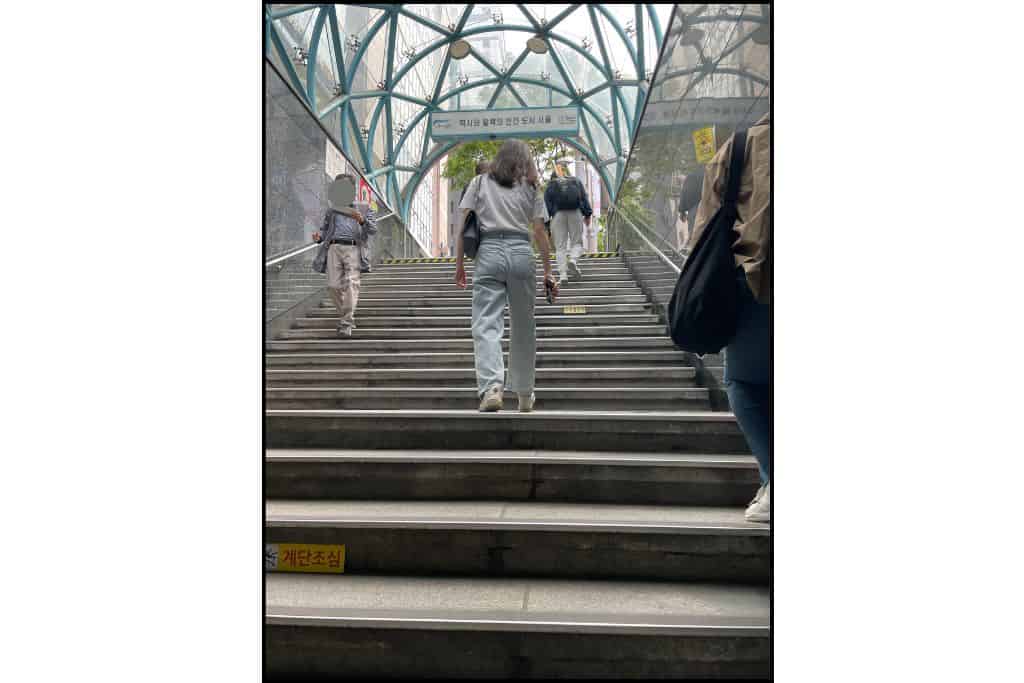 A photo looking up a staircase at Gangnam station.