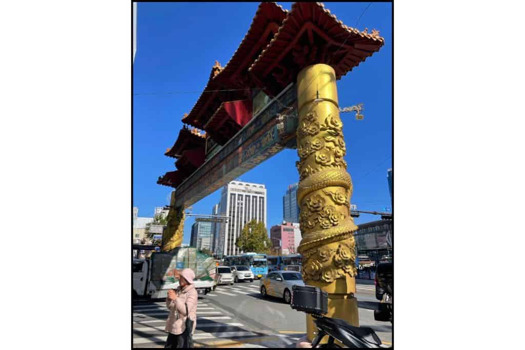 An ornate gold and red gate to Texas Street and China Town in Busan, near KTX station.