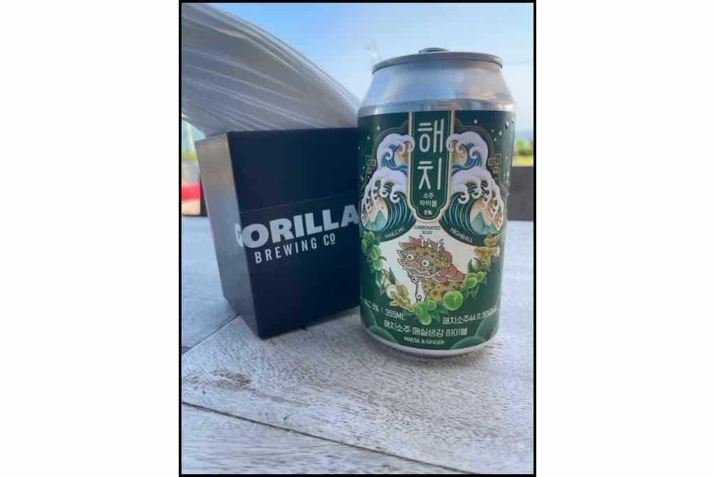 Haechi maeshil and ginger highball can next to Gorilla Brewing Co napkin holder in Busan.