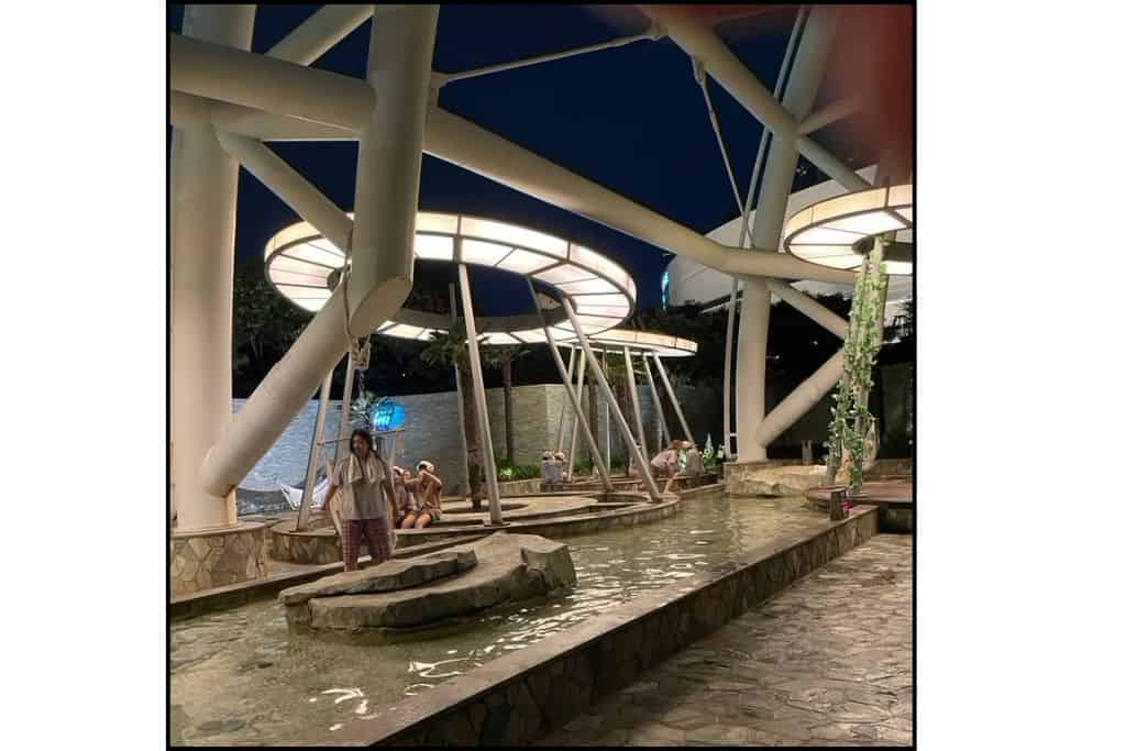 Outdoor foot bath area at Spa Land Centum City in Busan at night