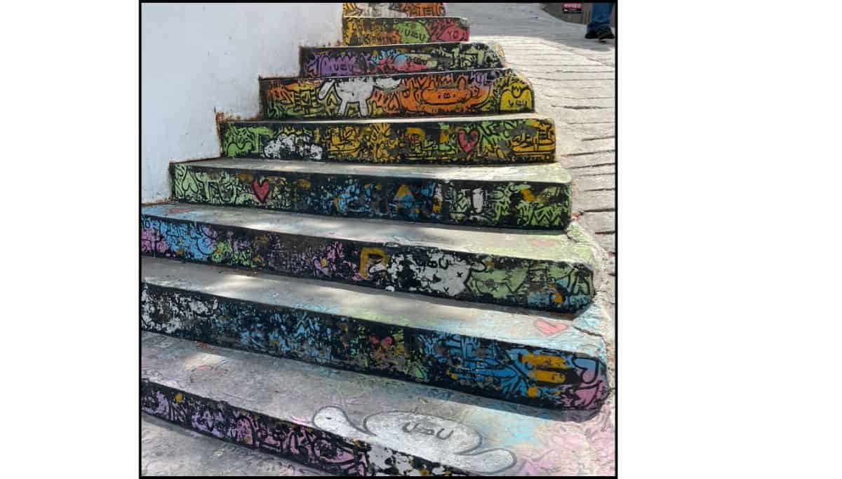 Colorfully painted stairway in Seoul, decorated with graffiti-style art and hearts, capturing Itaewon’s creative and eclectic vibe