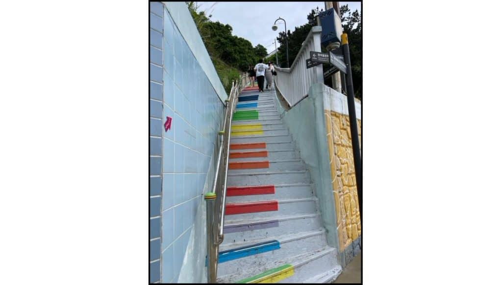 Colorful Piano-themed stairs connecting the coastal walkway to the upper village at Huinnyeoul Culture Village