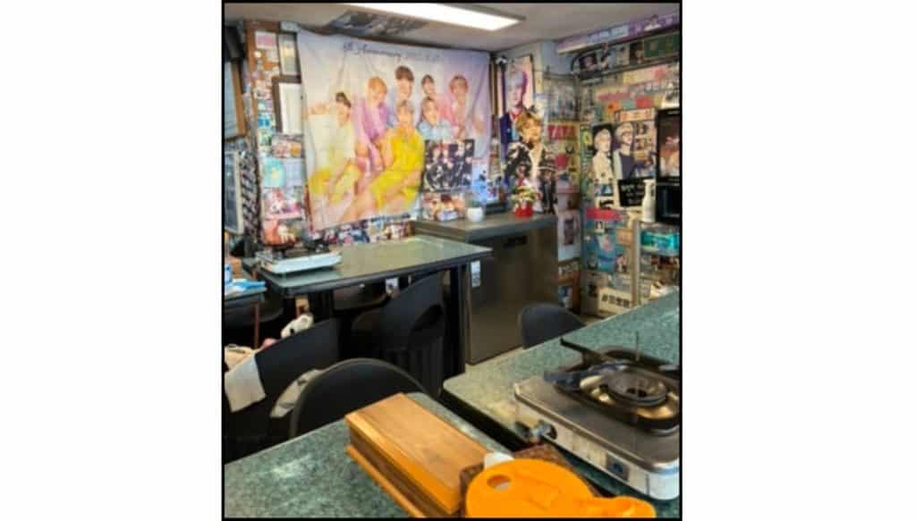 Interior of the restaurant Yoojung Sikdang in Seoul decorated with BTS posters, photos, and memorabilia