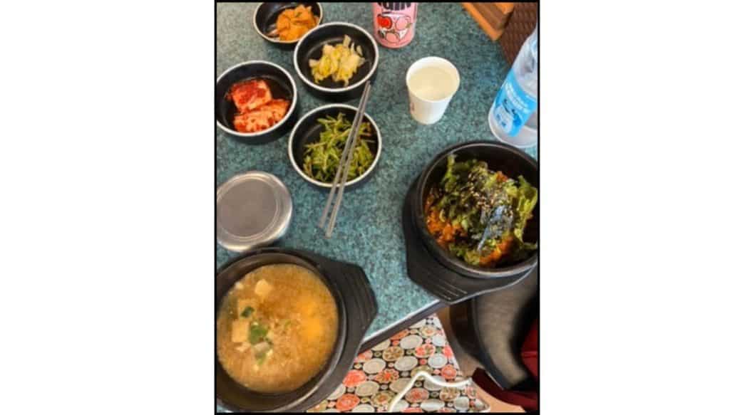 Korean meal at Yoojung Sikdang in Seoul with pork, soup, rice, and banchan side dishes