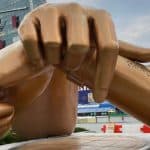 Large bronze sculpture of crossed hands making the Gangnam Style pose outside a building in Seoul.