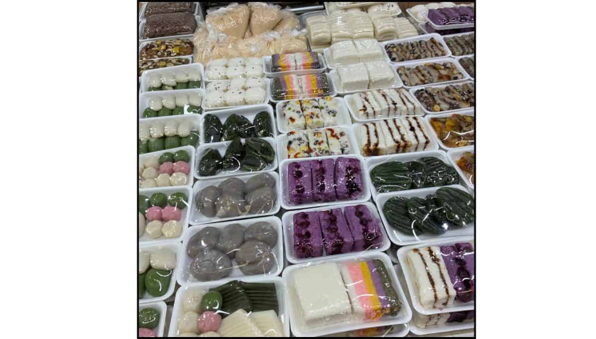 Assorted colorful Korean rice cakes displayed in trays at Mangwon Market in Seoul.
