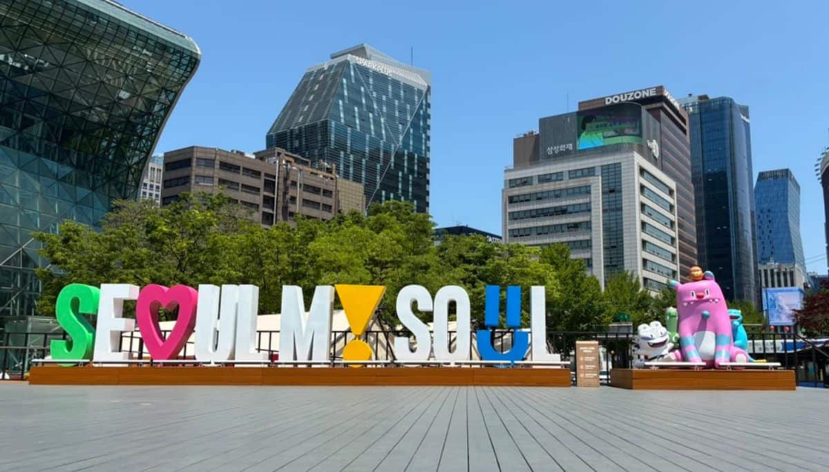 Seoul My Soul sign near Seoul City Hall, with modern buildings and colorful character statues in the background.