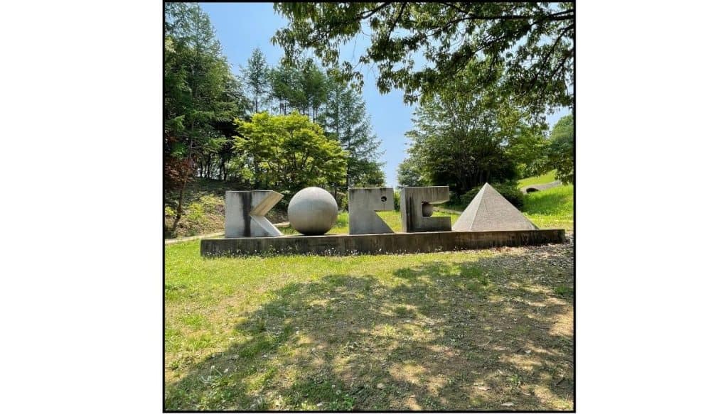 Geometric stone sculptures spelling KOREA surrounded by trees at Gonjiam Ceramic Park in Gonjiam, South Korea.